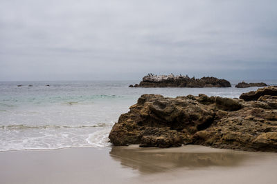 Scenic view of sea against cloudy sky