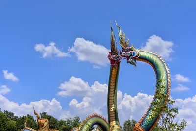  low angle twin stucco painted as a large serpent at pra kai keaw wang nakin, udon thani, thailand. 