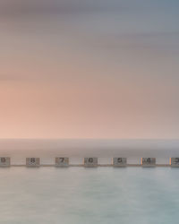 Scenic view of swimming pool against sky during sunrise