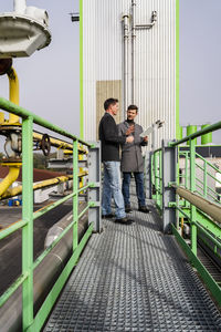 Businessmen discussing together at recycling plant