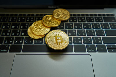 Close-up of coins on laptop keyboard