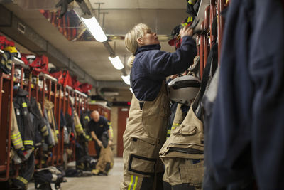 Female firefighter changing clothes in locker