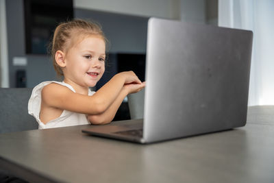 Portrait of boy using laptop at table