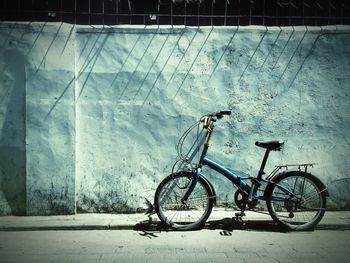 Bicycle parked on wall