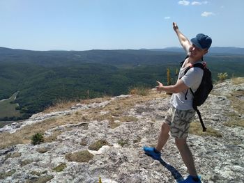 Full length of man standing on mountain against sky