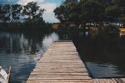 Pier over lake against sky