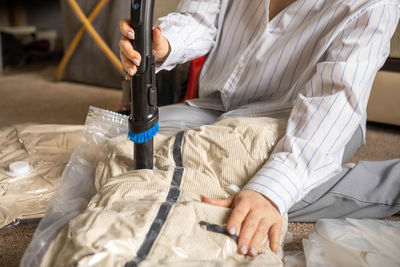 Midsection of man with iv drip on bed