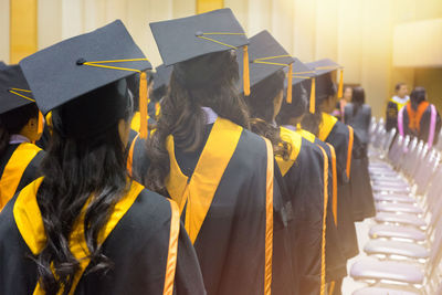 Rear view of women in graduation during ceremony