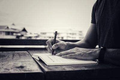 Close-up of man working in pen