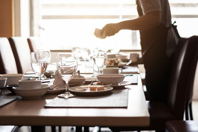 Midsection of man preparing food on table in restaurant