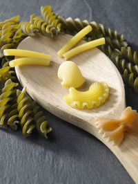 Close-up of pastas on spoon at slate