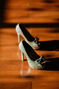 Close-up of high heels on wooden floor