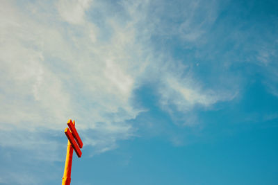 Low angle view of street light against blue sky