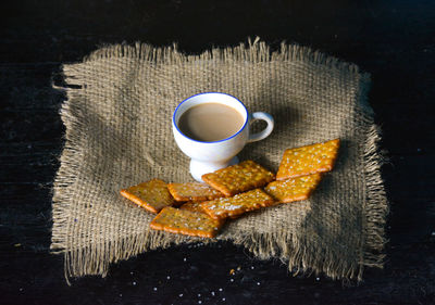 High angle view of coffee and cookies on table