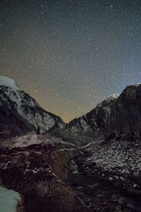 Scenic view of mountains against sky at night