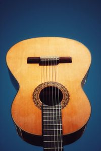 Close-up of guitar against blue background