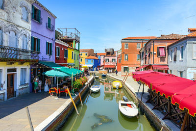 Boats in canal in city