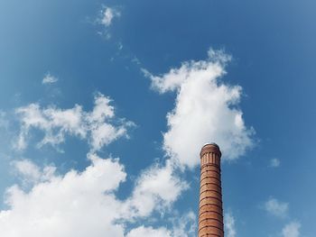 Low angle view of smoke stack against sky