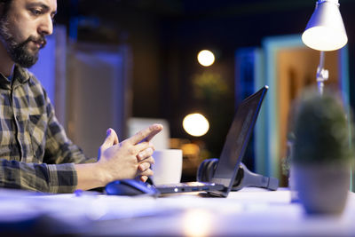Young man using mobile phone in office