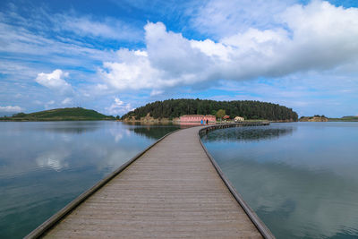 Pier over lake against sky