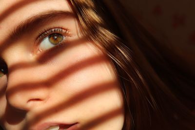 Close up profile of young woman with shadows and interesting lighting
