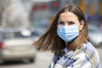 Portrait of young woman wearing mask