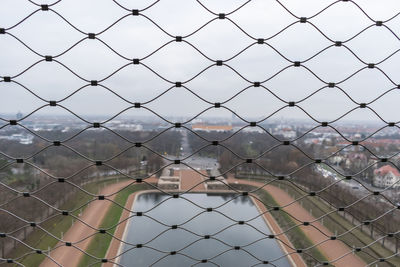 Close-up of chainlink fence against sky