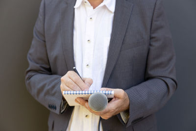 Midsection of man holding umbrella