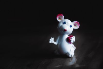 Close-up of stuffed toy on table against black background