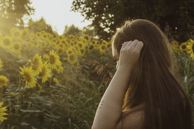 Side view of woman standing on field