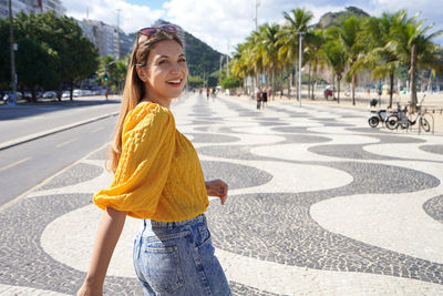 Copacabana girl walking on famous promenade in rio de janeiro, brazil