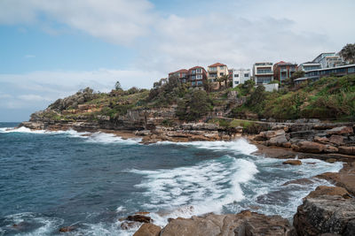 Scenic view of sea and buildings against sky