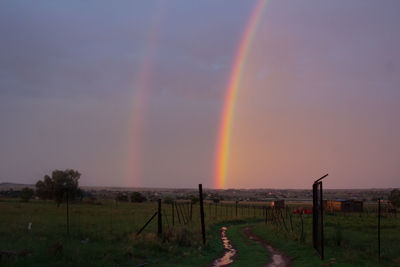 Scenic view of rainbow against sky during sunset
