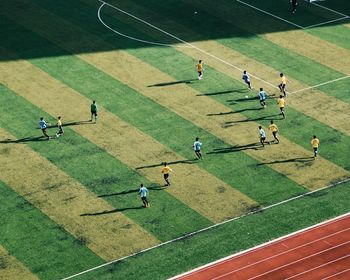 People playing soccer on landscape