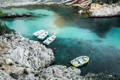 High angle view of boats moored by rock formations in river