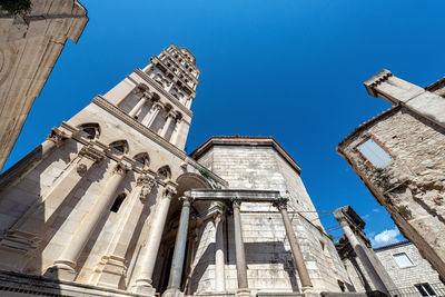 Low angle view of historic building against clear blue sky