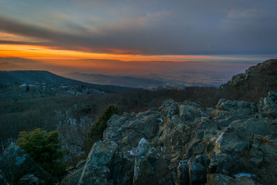 Scenic view of rocky mountains against sky during sunset