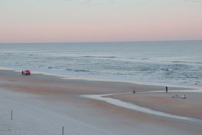 Scenic view of beach against sky during sunset