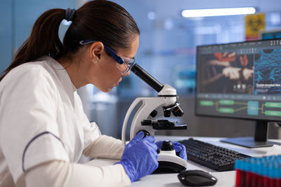 Side view of doctor working in laboratory