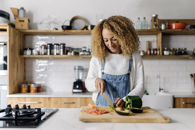 Woman standing in kitchen at home