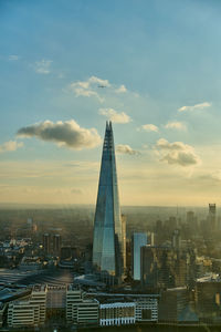 Shard skyscrapper in city against sky during sunset