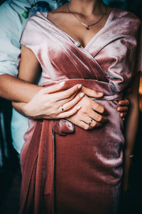 Midsection of woman holding hands