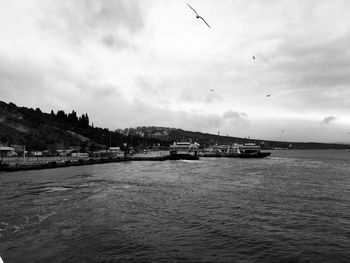 Scenic view of sea by buildings against sky