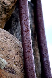 Close-up of rusty metal against sky