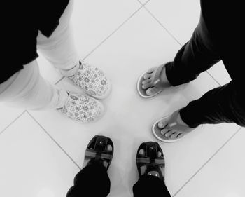 Low section of person standing on tiled floor