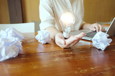 Close-up of man sitting on table at home