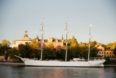 Sailboats in river against sky