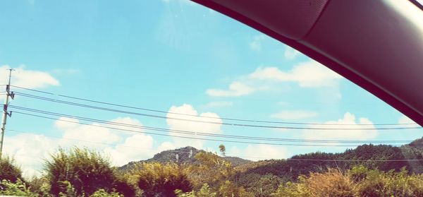 Low angle view of power lines against sky