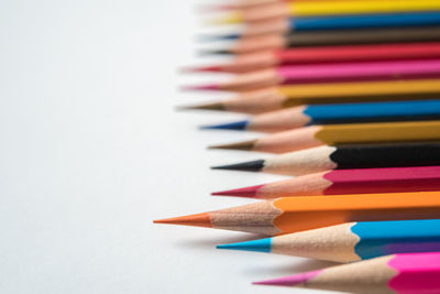 High angle view of multi colored pencils against gray background