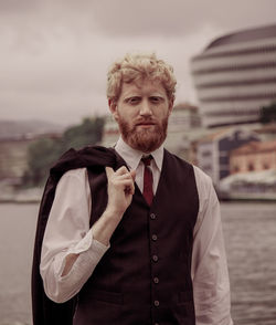 Portrait of young businessman standing outdoors